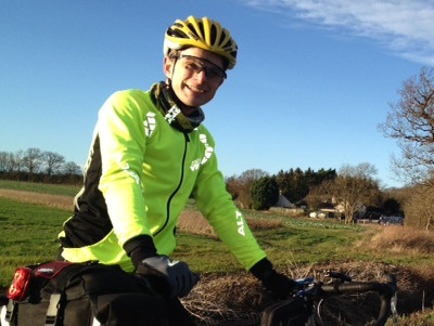 The author standing next to the roadside wearing a flourescent yellow cycling jersey with retroreflective sections.